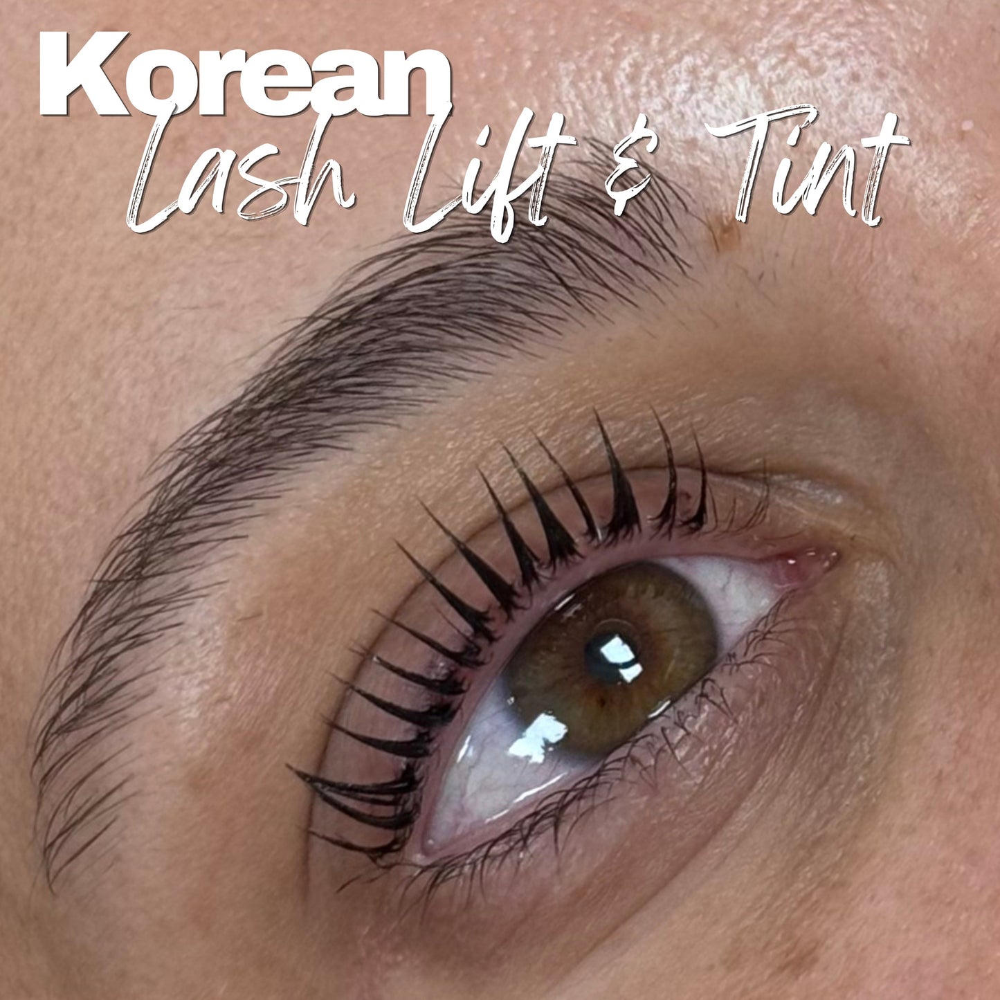 Close-up of a person's eye with long, dark, curled eyelashes and a filled eyebrow, with overlaid text reading 'Korean Lash Lift & Tint'.